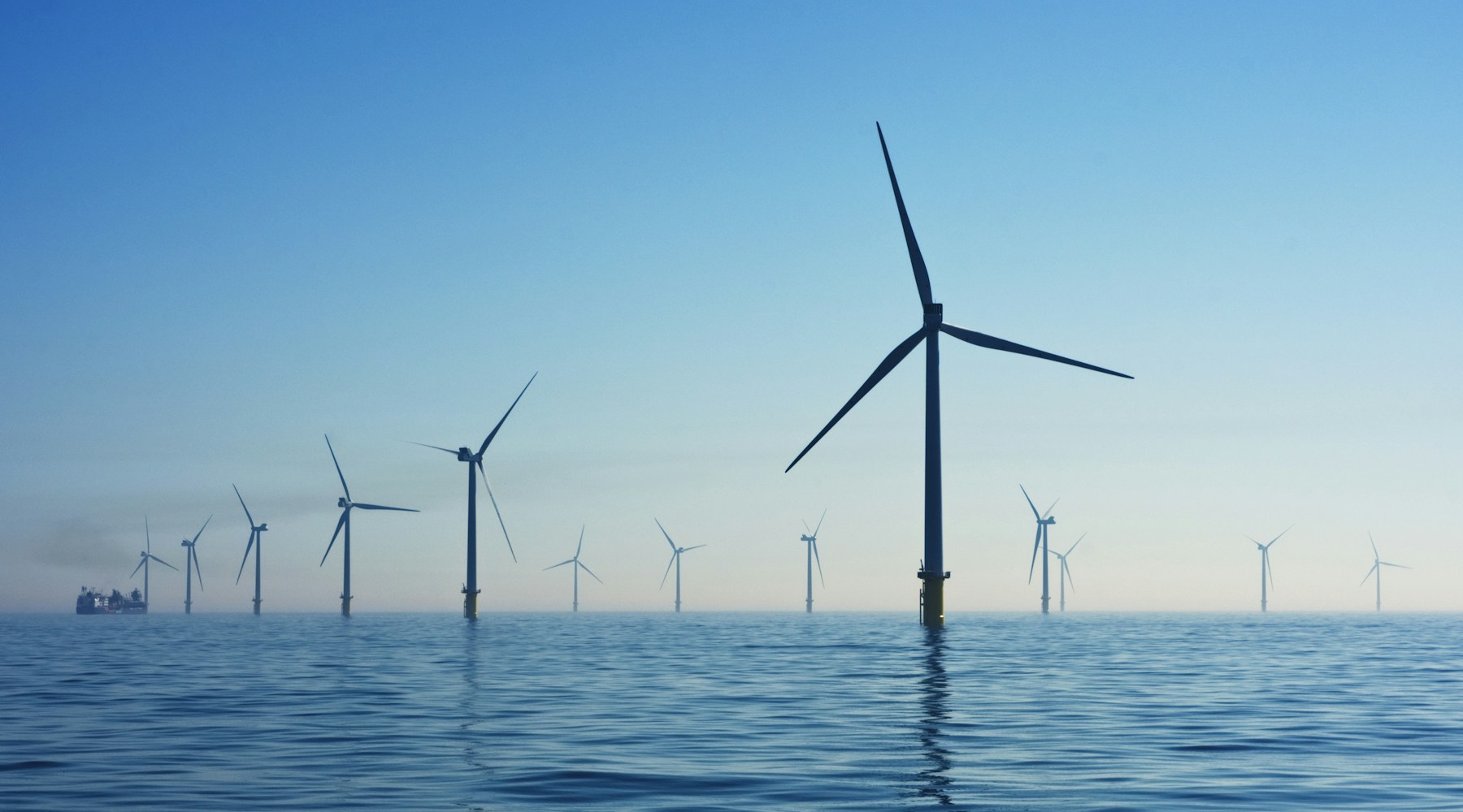 Offshore wind turbines in calm blue water