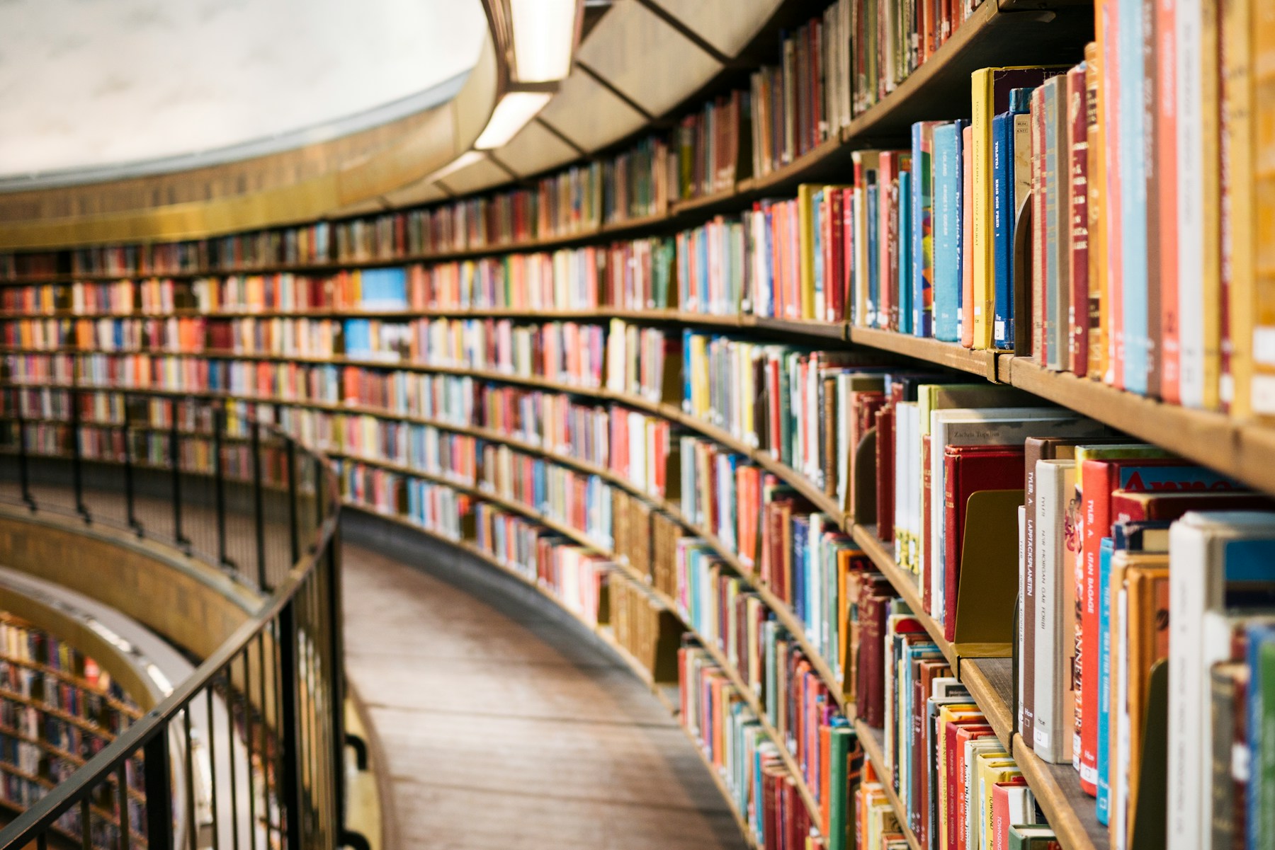 Curved library shelves filled with books